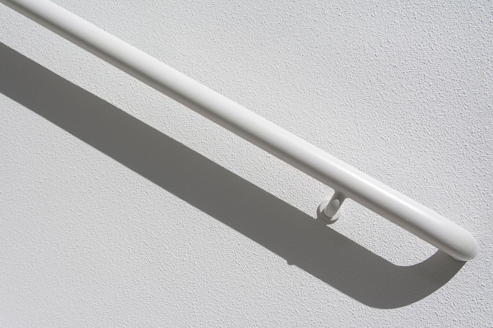 Close-up of a white wall-mounted grab rail
