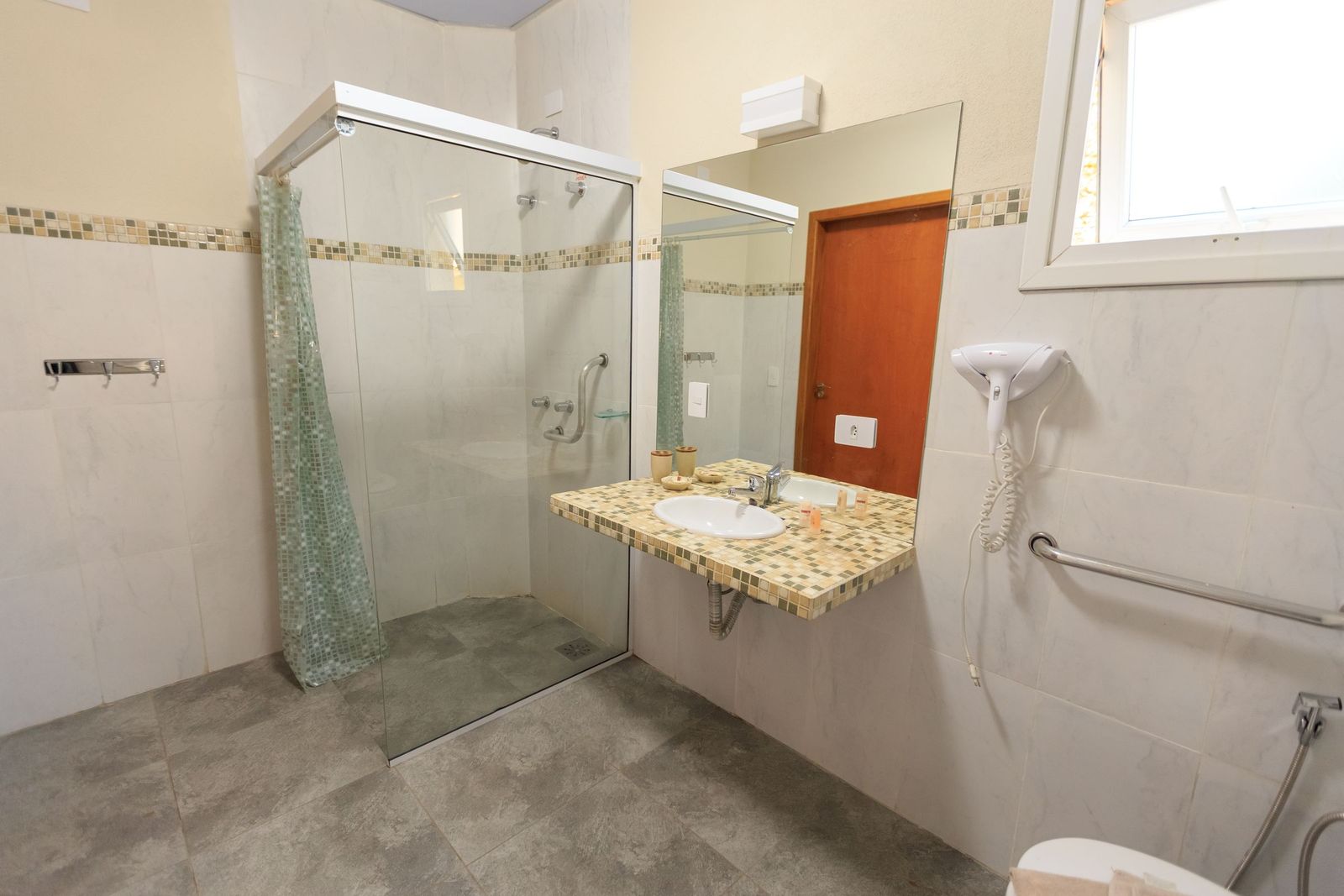 Accessible bathroom with a grab bar and a walk-in shower